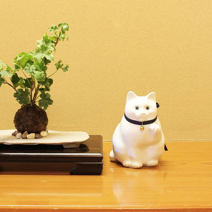 Maneki Neko coin bank, porcelain lucky cat bank, Hizen Yoshida Ware Maneki Neko, KataKoto beckoning cat, Japanese money box cat, black Maneki Neko bank, white Maneki Neko bank, Japanese store opening gift, ceramic cat coin bank, traditional Japanese porcelain cat, chubby lucky cat figurine, handcrafted Maneki Neko Japan, black gold lucky cat ornament, white navy Maneki Neko money bank, Japanese prosperity charm, artisan porcelain Maneki Neko.