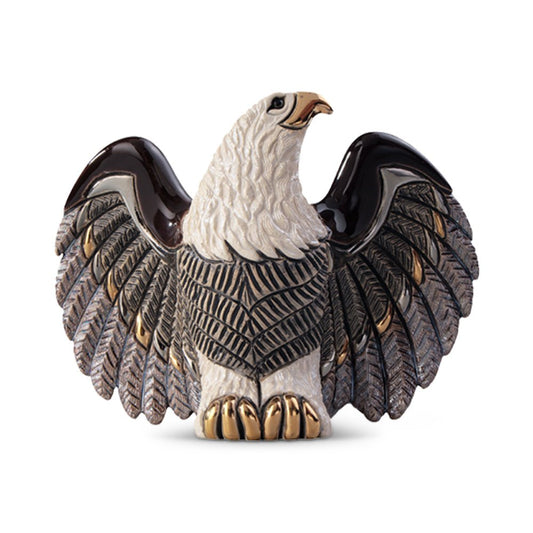 Handcrafted ceramic bald eagle figurine with detailed feathers in brown, white, and gold tones; realistic soaring pose on rocky base; patriotic American wildlife sculpture for home or office decor, collectible eagle statue symbolizing freedom and strength.