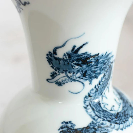 Mikawachi ware vase, Japanese dragon vase, Hirado Shozan porcelain, blue and white porcelain vase, Nagasaki pottery, Japanese porcelain art, indigo dragon vase, traditional Japanese ceramics, dragon motif home décor, Japanese gift vase, blue dragon porcelain, Asian dragon symbolism vase, hand-painted porcelain Japan, Japanese decorative vase, luxury porcelain home décor, Mikawachi dragon design, cultural Japanese gifts, auspicious Japanese art