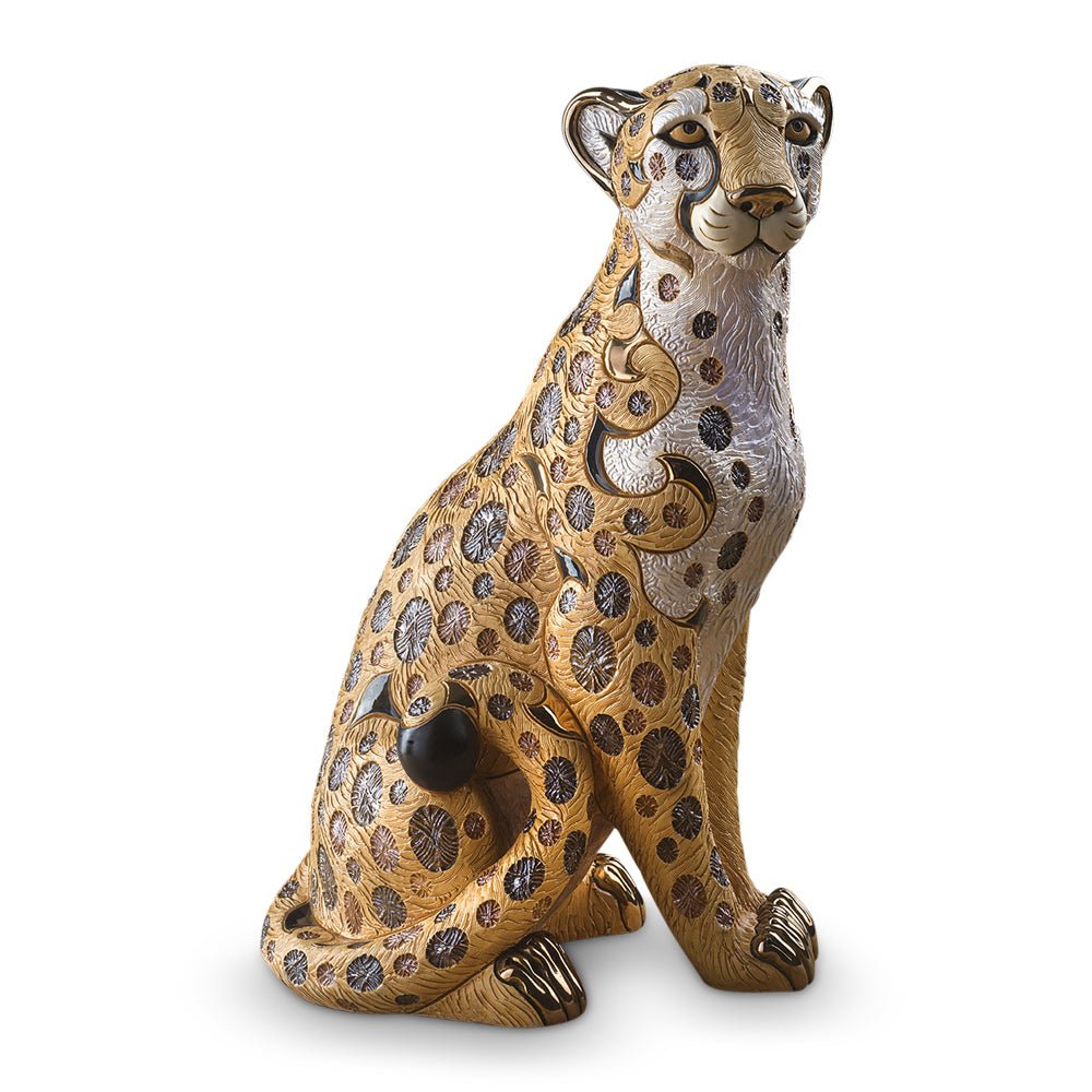 Handmade ceramic animal sculptures, specifically limited edition collectible wildlife figurines. Its materials and craftsmanship place it in the category of fine decorative ceramic art. Cheetah statue, luxury animal figurine, Uruguayan ceramic art, hand-painted ceramic cheetah, and gold-accented cheetah sculpture.