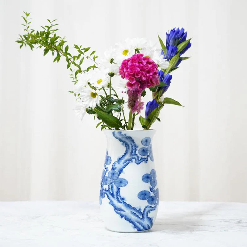 Mikawachi ware vase, Japanese porcelain vase, hand-painted pine tree vase, Hirado Shozan pottery, blue and white Japanese vase, pine tree motif vase, Nagasaki porcelain art, traditional Japanese pottery gift, Japanese wedding vase, Japanese anniversary gift, porcelain vase with pine design, symbolic Japanese home decor, luxury Japanese vase, seasonal Japanese vase, handcrafted Japanese porcelain, pine tree longevity symbol, Japanese cultural gift vase, artisan painted Japanese vase