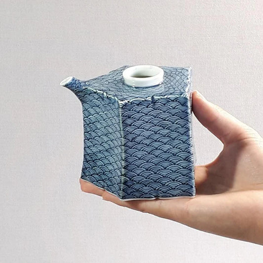 Mikawachi ware porcelain, Hirado Shozan pottery, Seigaiha porcelain set, Japanese wave pattern porcelain, blue and white porcelain Japan, pentagonal porcelain vessel, Japanese porcelain cup set, traditional Japanese tableware, handcrafted Japanese porcelain, Nagasaki porcelain ware, Seigaiha tea set, cultural Japanese giftware, artisanal porcelain Japan, wave motif ceramic set