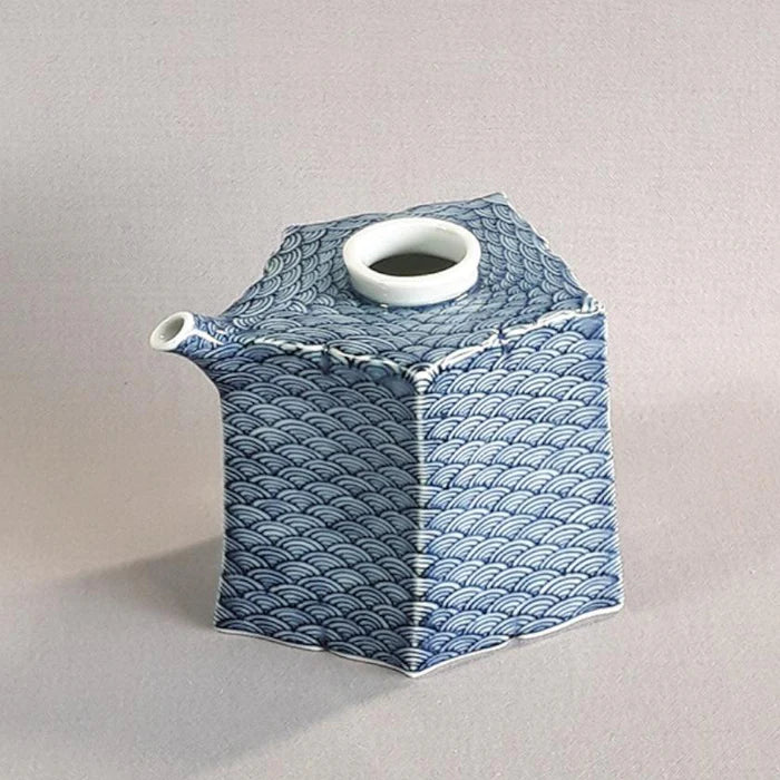 Mikawachi ware porcelain, Hirado Shozan pottery, Seigaiha porcelain set, Japanese wave pattern porcelain, blue and white porcelain Japan, pentagonal porcelain vessel, Japanese porcelain cup set, traditional Japanese tableware, handcrafted Japanese porcelain, Nagasaki porcelain ware, Seigaiha tea set, cultural Japanese giftware, artisanal porcelain Japan, wave motif ceramic set