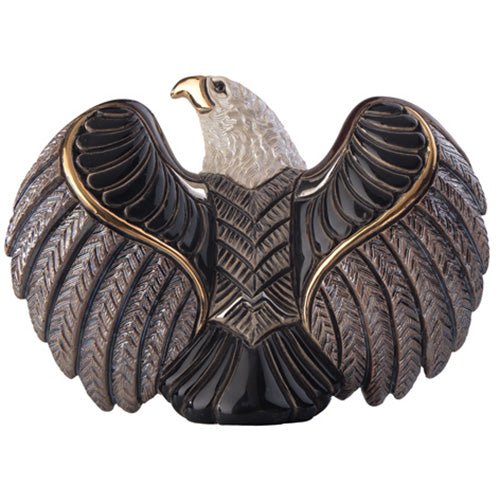 Handcrafted ceramic bald eagle figurine with detailed feathers in brown, white, and gold tones; realistic soaring pose on rocky base; patriotic American wildlife sculpture for home or office decor, collectible eagle statue symbolizing freedom and strength.