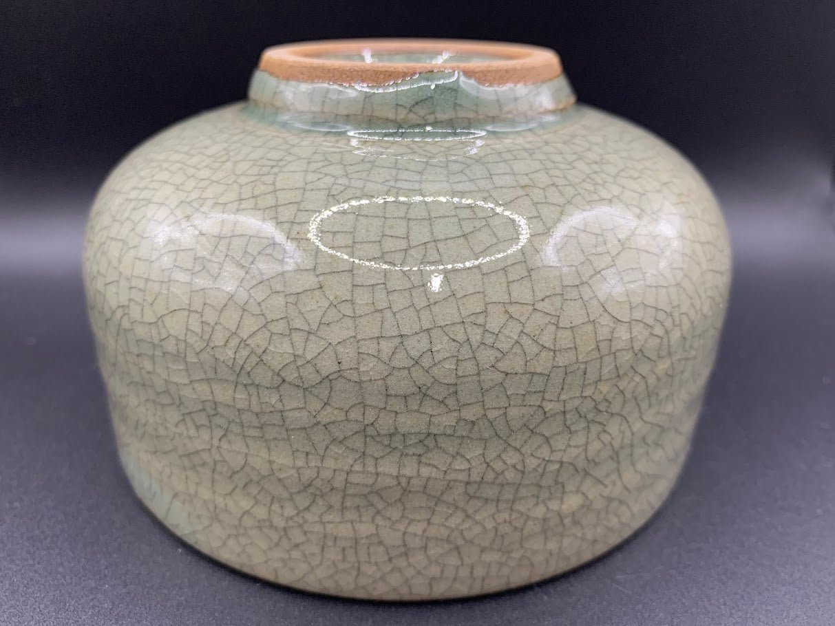 Japanese celadon pottery, handmade celadon tea bowl, ribbed ceramic tea bowl, carved leaf motif pottery, traditional Japanese ceramics, Longquan-style celadon ware, matcha chawan bowl, artisanal tea ceremony bowl, crackle glaze pottery, Song dynasty style ceramics, Japanese green glaze bowl, hand-thrown Japanese pottery, tea culture ceramics, Japanese chawan design, antique-style Japanese bowl, leaf pattern pottery, ribbed matcha bowl, celadon carving techniques, Japanese celadon glaze art, traditional Japa
