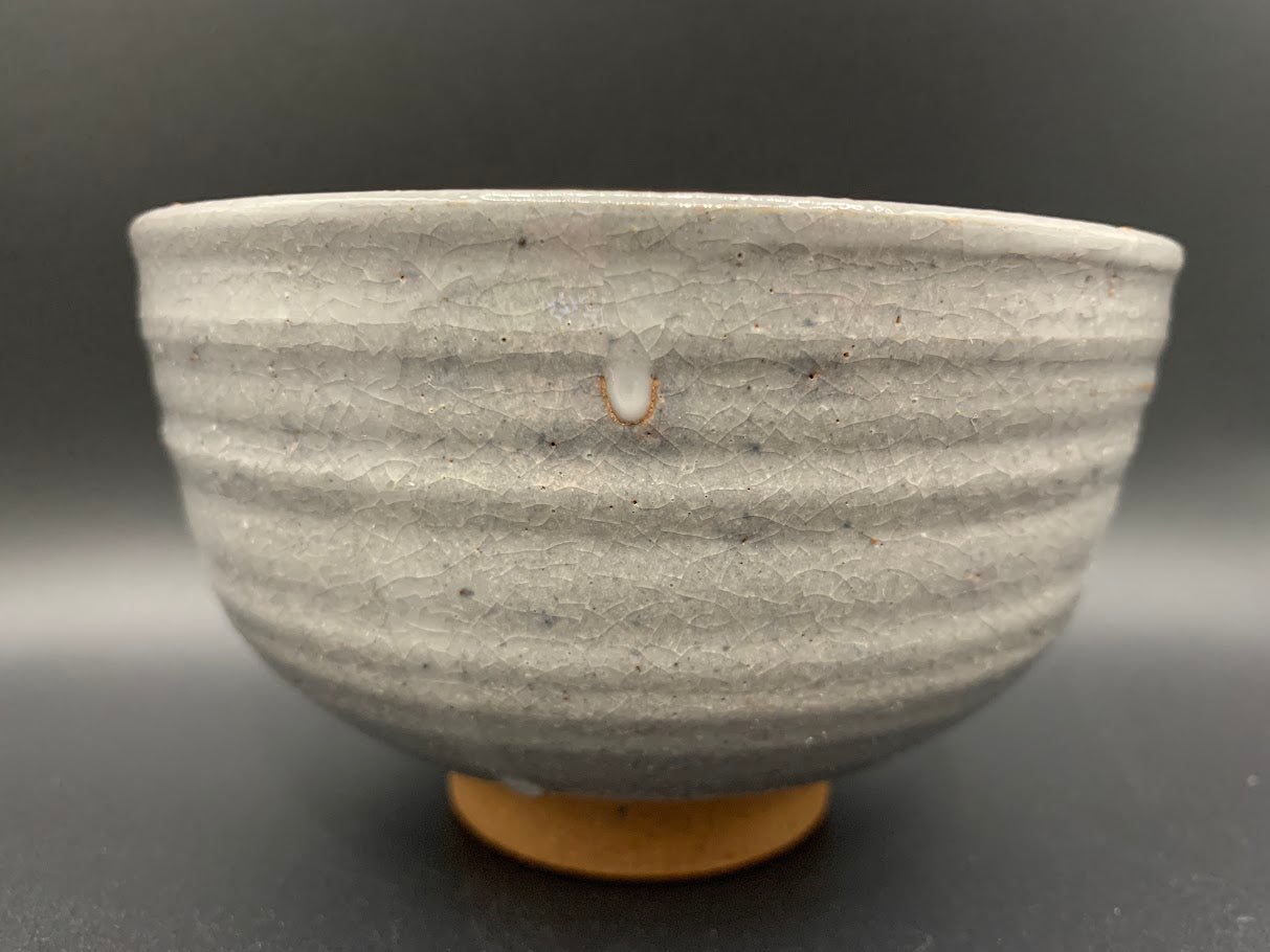 Japanese celadon pottery, handmade celadon tea bowl, ribbed ceramic tea bowl, carved leaf motif pottery, traditional Japanese ceramics, Longquan-style celadon ware, matcha chawan bowl, artisanal tea ceremony bowl, crackle glaze pottery, Song dynasty style ceramics, Japanese green glaze bowl, hand-thrown Japanese pottery, tea culture ceramics, Japanese chawan design, antique-style Japanese bowl, leaf pattern pottery, ribbed matcha bowl, celadon carving techniques, Japanese celadon glaze art, traditional Japa