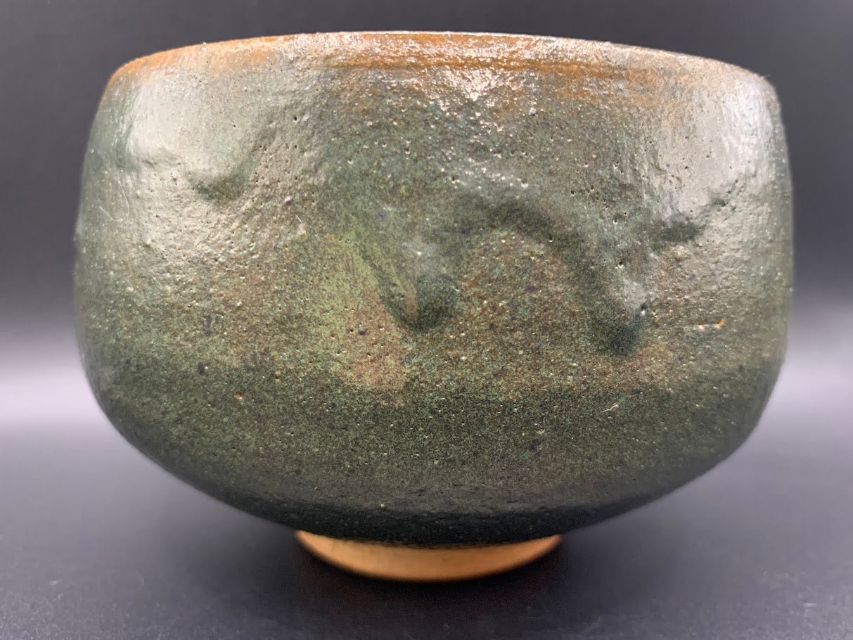 Japanese celadon pottery, handmade celadon tea bowl, ribbed ceramic tea bowl, carved leaf motif pottery, traditional Japanese ceramics, Longquan-style celadon ware, matcha chawan bowl, artisanal tea ceremony bowl, crackle glaze pottery, Song dynasty style ceramics, Japanese green glaze bowl, hand-thrown Japanese pottery, tea culture ceramics, Japanese chawan design, antique-style Japanese bowl, leaf pattern pottery, ribbed matcha bowl, celadon carving techniques, Japanese celadon glaze art, traditional Japa