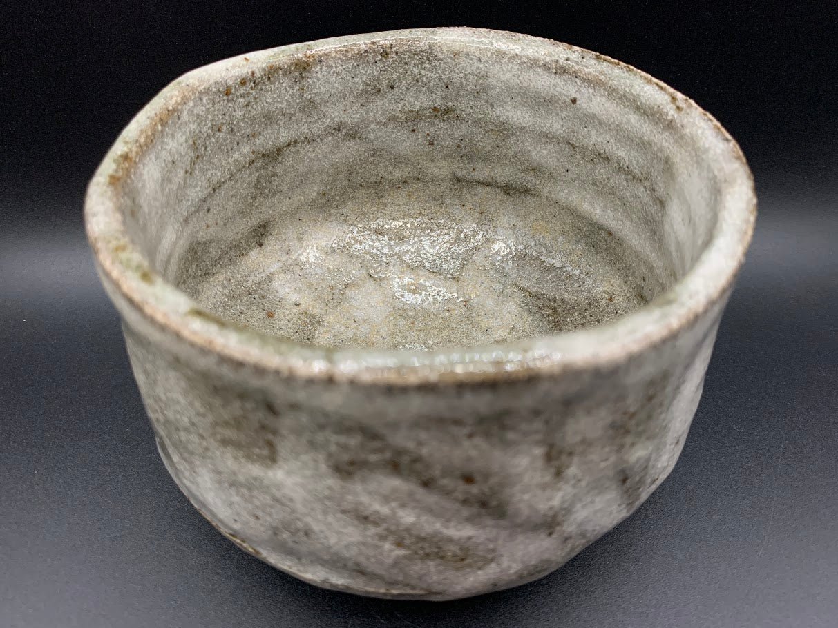 Japanese celadon pottery, handmade celadon tea bowl, ribbed ceramic tea bowl, carved leaf motif pottery, traditional Japanese ceramics, Longquan-style celadon ware, matcha chawan bowl, artisanal tea ceremony bowl, crackle glaze pottery, Song dynasty style ceramics, Japanese green glaze bowl, hand-thrown Japanese pottery, tea culture ceramics, Japanese chawan design, antique-style Japanese bowl, leaf pattern pottery, ribbed matcha bowl, celadon carving techniques, Japanese celadon glaze art, traditional Japa