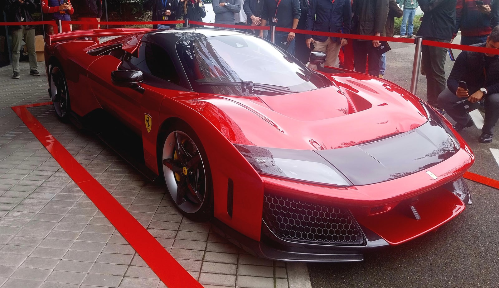 A red Ferrari F80 shown from the front three-quarter angle at Maranello