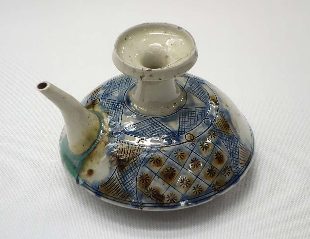Okinawa pottery, Ryukyu ceramics, Yachimun ware, Tsuboya kilns, Okinawan pottery village, traditional Japanese pottery, arayachi unglazed pottery, joyachi glazed ware, shisa lion statues, red clay roof tiles, Okinawan ceramic history