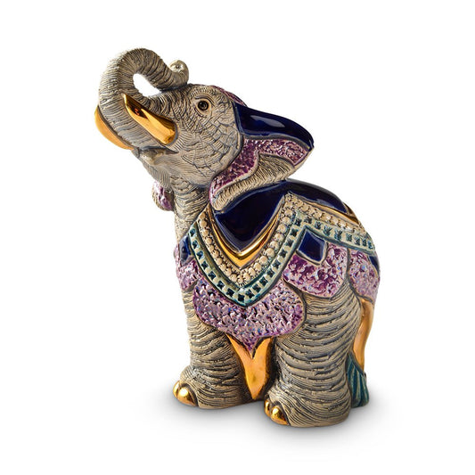 Hand‑carved elephant sculpture. Artisanal enamel elephant figurine. Small platinum‑accent animal figurine. Uruguayan handmade elephant statue. Gold‑trim elephant décor piece. Handcrafted and gift‑boxed for home décor or collector’s display.