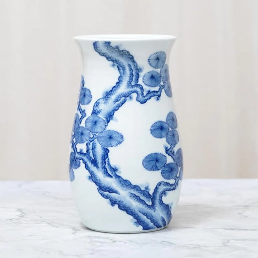 Mikawachi ware vase, Japanese porcelain vase, hand-painted pine tree vase, Hirado Shozan pottery, blue and white Japanese vase, pine tree motif vase, Nagasaki porcelain art, traditional Japanese pottery gift, Japanese wedding vase, Japanese anniversary gift, porcelain vase with pine design, symbolic Japanese home decor, luxury Japanese vase, seasonal Japanese vase, handcrafted Japanese porcelain, pine tree longevity symbol, Japanese cultural gift vase, artisan painted Japanese vase