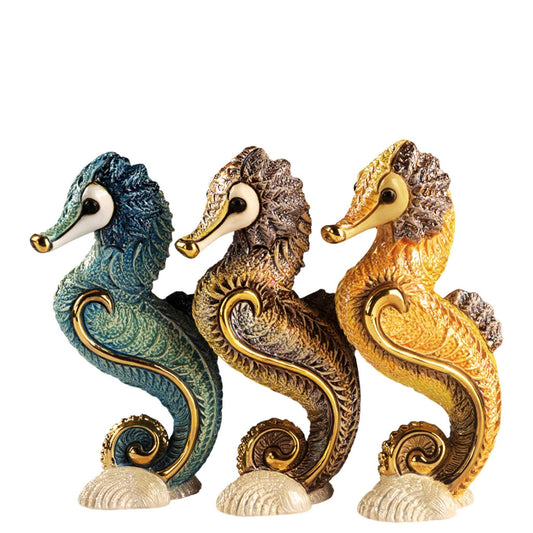 Ceramic seahorse figurines. Handcrafted marine animal sculptures. Enamel sea creature decor. Coastal themed ceramic decor. Seahorse sculpture handmade. Ocean-inspired home ornaments. Seahorse trio statue set. Artisan nautical figurines. Seahorse home decoration. Gold accent ceramic sea animal. De Rosa seahorse collection