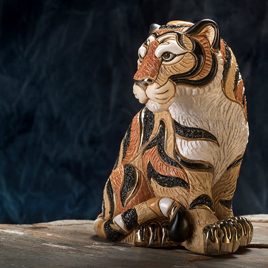 Hand‑Carved Tiger Figurine. Sitting Tiger Animal Sculpture. Artisan Wildlife ceramic Carving. Gold & Platinum Accent Tiger Statue. Symbolic Power Animal Figure. Rustic Tiger Home Décor Piece. Compact Office Desk Wildlife Art. Uruguay Hand‑Painted Animal Statuette. Courage Symbol Animal Sculpture. Tiger Gift Boxed Art Piece.