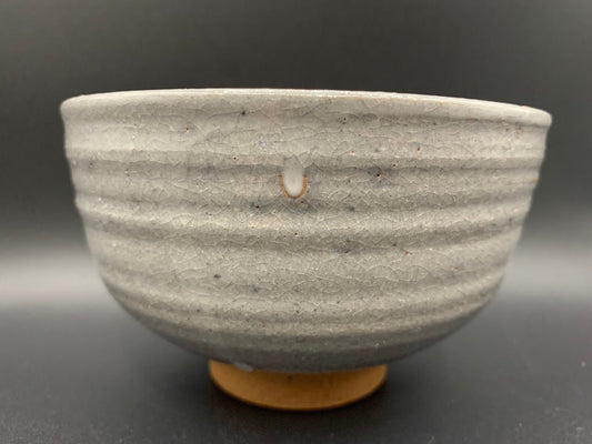 Japanese celadon pottery, handmade celadon tea bowl, ribbed ceramic tea bowl, carved leaf motif pottery, traditional Japanese ceramics, Longquan-style celadon ware, matcha chawan bowl, artisanal tea ceremony bowl, crackle glaze pottery, Song dynasty style ceramics, Japanese green glaze bowl, hand-thrown Japanese pottery, tea culture ceramics, Japanese chawan design, antique-style Japanese bowl, leaf pattern pottery, ribbed matcha bowl, celadon carving techniques, Japanese celadon glaze art, traditional Japa
