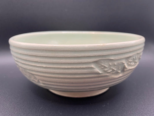 Japanese celadon pottery, handmade celadon tea bowl, ribbed ceramic tea bowl, carved leaf motif pottery, traditional Japanese ceramics, Longquan-style celadon ware, matcha chawan bowl, artisanal tea ceremony bowl, crackle glaze pottery, Song dynasty style ceramics, Japanese green glaze bowl, hand-thrown Japanese pottery, tea culture ceramics, Japanese chawan design, antique-style Japanese bowl, leaf pattern pottery, ribbed matcha bowl, celadon carving techniques, Japanese celadon glaze art, traditional Japa
