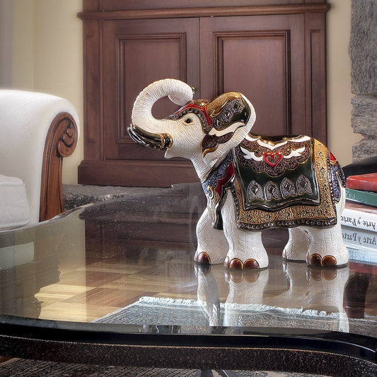 White ceramic elephant figurine with gold and red accents, hand‑painted, 30×28 cm, Indian symbolic art décor. Hand‑painted white elephant ceramic figurine (30×28 cm), limited to 1,000. Symbol of purity, wisdom & cultural elegance in home decor.